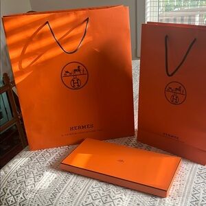 Two Hermes gift bags and scarf box sold as a set.